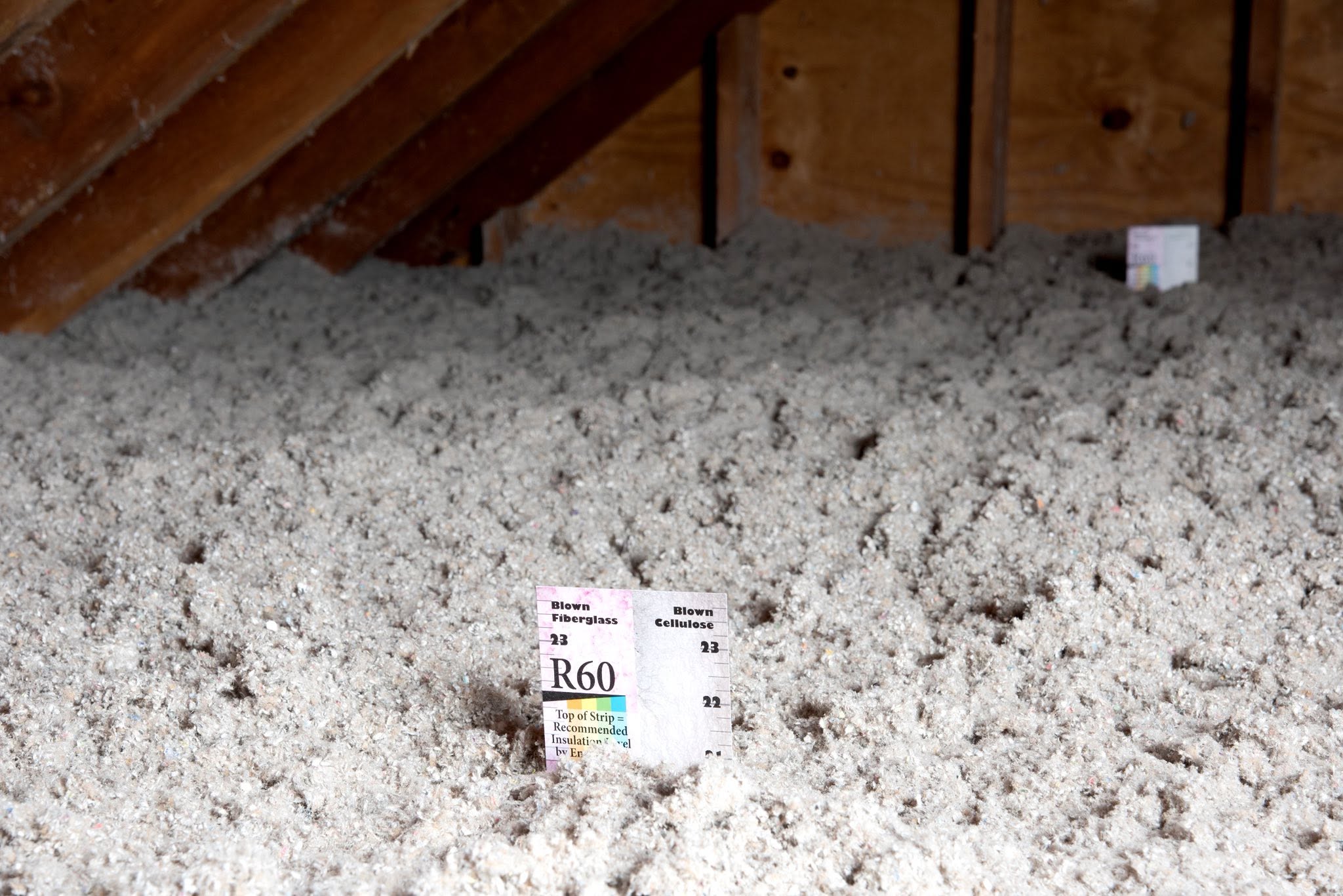 Depth marker reading R-60 standing in fresh blown cellulose